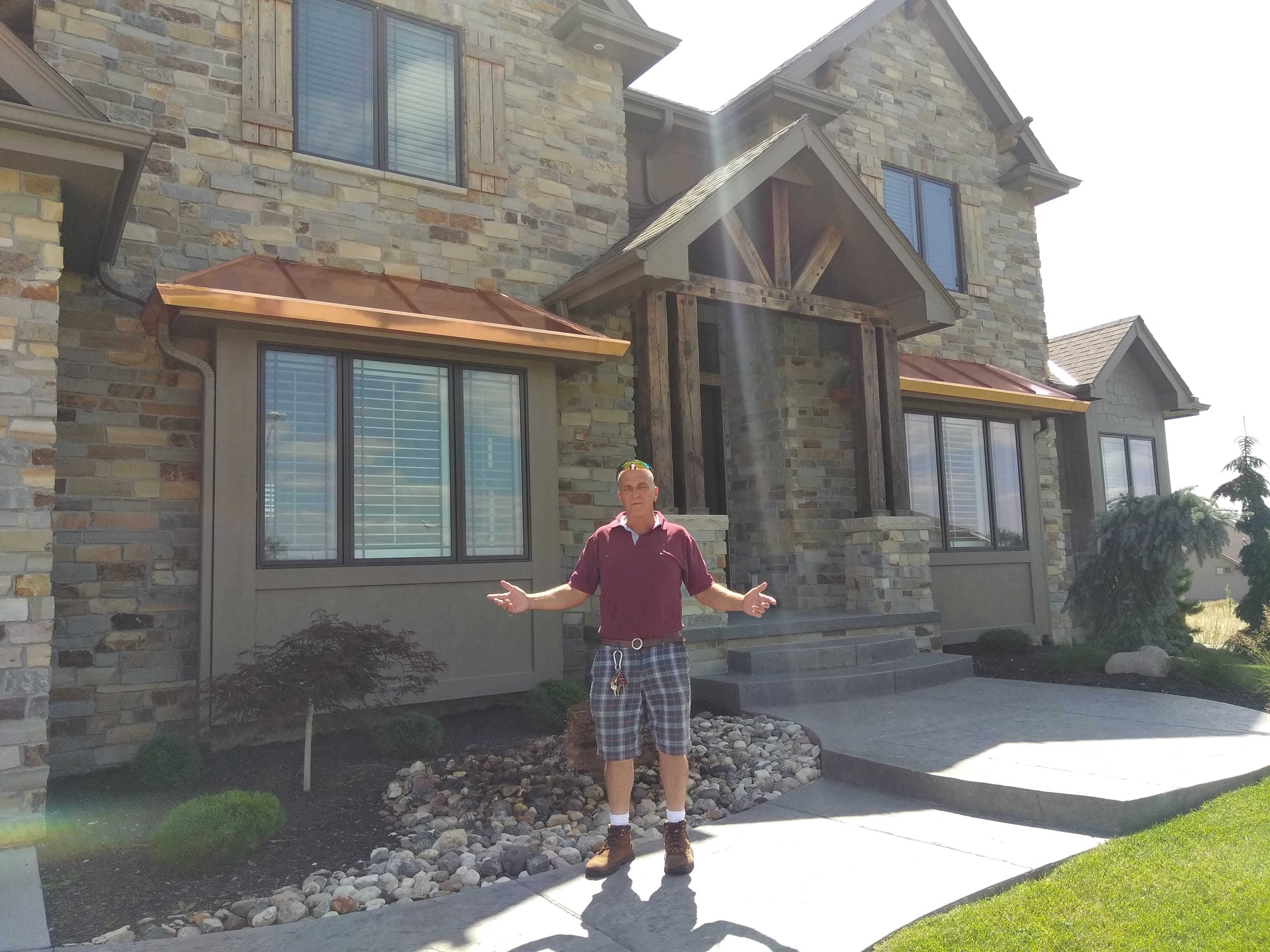Copper standing seam roofs above 11-ft bay windows with trough gutters